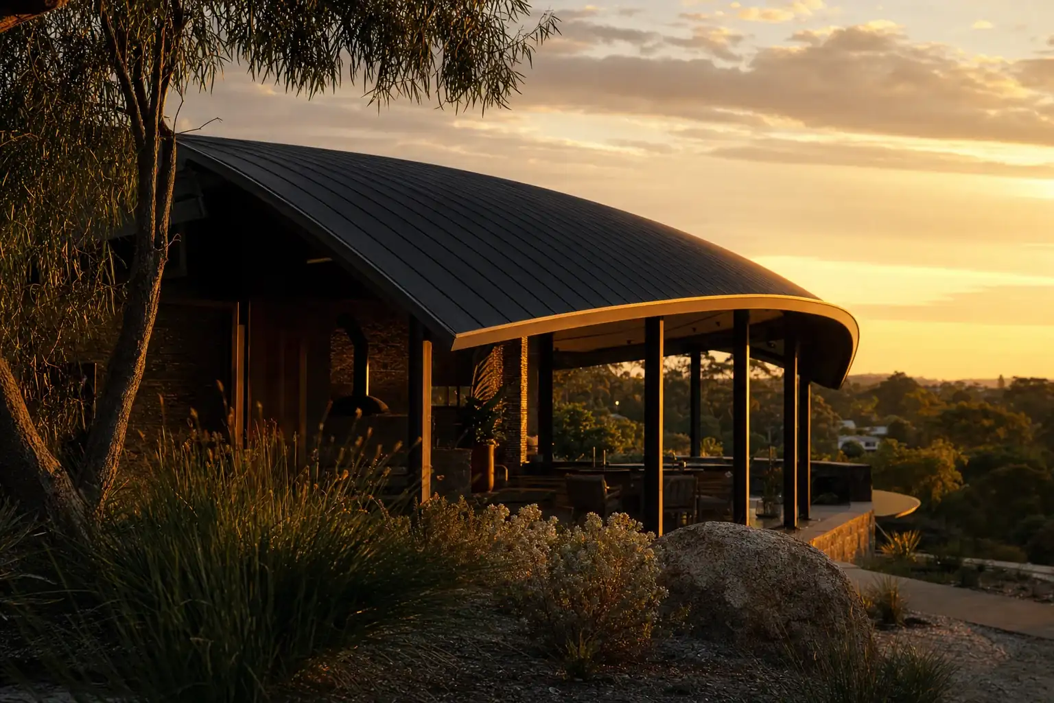 Charcoal Colorbond dome roof patio curving against a warm golden Perth sky